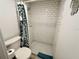 Bright bathroom features white subway tile shower and matching toilet at 84 Heather Point Ct, New Smyrna Beach, FL 32169