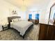 Cozy bedroom with queen size bed, beach themed decor, hardwood style floors, and lots of light at 84 Heather Point Ct, New Smyrna Beach, FL 32169