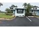 Inviting coastal townhome featuring black shutters, assigned parking and tidy front landscaping at 84 Heather Point Ct, New Smyrna Beach, FL 32169