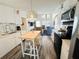Open concept kitchen with white cabinetry, hardwood floors and seamless access to the living room at 84 Heather Point Ct, New Smyrna Beach, FL 32169