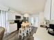 Modern white kitchen with stainless steel appliances, casual dining table, and lots of light at 84 Heather Point Ct, New Smyrna Beach, FL 32169