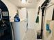 Bright laundry room with stacked washer/dryer and storage space at 84 Heather Point Ct, New Smyrna Beach, FL 32169