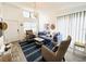 Bright living room featuring a comfortable blue sofa, high ceilings and a coastal theme at 84 Heather Point Ct, New Smyrna Beach, FL 32169
