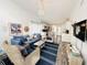 Cozy living room with beachy accents, comfortable seating, and hardwood style floors at 84 Heather Point Ct, New Smyrna Beach, FL 32169