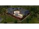 An aerial view shows a home's backyard, patio, landscaping, and mature trees at 94 Cedar Dunes Dr, New Smyrna Beach, FL 32169