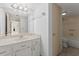 Bright bathroom with a single sink vanity, toilet, and a shower at 94 Cedar Dunes Dr, New Smyrna Beach, FL 32169