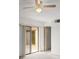 This bright bedroom features light walls, a ceiling fan, and sliding glass doors to the patio at 94 Cedar Dunes Dr, New Smyrna Beach, FL 32169