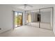 Bright bedroom with a sliding glass door, fan, and mirror closet doors at 94 Cedar Dunes Dr, New Smyrna Beach, FL 32169
