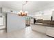 Bright kitchen with white cabinets, stainless steel appliances, and a large island with granite countertops at 94 Cedar Dunes Dr, New Smyrna Beach, FL 32169