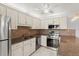 Modern kitchen featuring stainless steel appliances, granite counters, and white cabinetry at 94 Cedar Dunes Dr, New Smyrna Beach, FL 32169