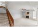 Spacious living room with a cozy fireplace and staircase at 94 Cedar Dunes Dr, New Smyrna Beach, FL 32169