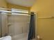 Bright bathroom with shower and yellow walls at 125 Rio Vista Dr, Edgewater, FL 32132