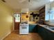 Cozy kitchen featuring retro cabinets, open shelving, a gas range, and vintage charm at 125 Rio Vista Dr, Edgewater, FL 32132