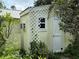 Exterior shot of shed with AC unit and climbing lattice at 125 Rio Vista Dr, Edgewater, FL 32132