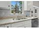 Close-up of kitchen countertop, sink, faucet, and cabinetry with attractive tile backsplash at 1290 9Th St, Orange City, FL 32763