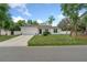 Inviting home with a well-kept lawn, charming curb appeal, and a serene neighborhood at 1290 9Th St, Orange City, FL 32763