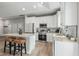 Bright, spacious kitchen with white cabinets, stainless appliances, and an island with barstool seating at 1290 9Th St, Orange City, FL 32763