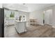 Open kitchen with a large island, white cabinets, and a dining area next to sliding glass doors at 1290 9Th St, Orange City, FL 32763