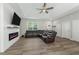 Cozy living room featuring a modern fireplace, hardwood floors, and ample natural light at 1290 9Th St, Orange City, FL 32763