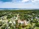 Aerial view showing approximate property lines within a tree-filled neighborhood close to the water at 130 N Gaines St, Oak Hill, FL 32759