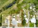 Aerial view highlighting property lines surrounded by green space and a creek nearby at 130 N Gaines St, Oak Hill, FL 32759