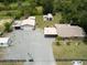 Aerial view of a home with multiple outbuildings and generous yard space at 130 N Gaines St, Oak Hill, FL 32759