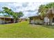View of multiple outbuildings in the backyard area of the property at 130 N Gaines St, Oak Hill, FL 32759