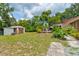 View of the backyard showing the grass, shed and deck area off the back of the house at 130 N Gaines St, Oak Hill, FL 32759