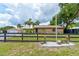Ranch style home with neutral paint, black fence, and lush greenery at 130 N Gaines St, Oak Hill, FL 32759