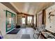 View of the sunroom with tiled flooring, an exterior door, multiple windows and a ceiling fan at 130 N Gaines St, Oak Hill, FL 32759
