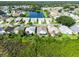 An aerial view of the neighborhood featuring houses, a serene pond, and lush landscaping at 1327 Wayne Ave, New Smyrna Beach, FL 32168