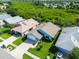 Aerial view of the home and surrounding area, lush landscaping and mature trees at 1327 Wayne Ave, New Smyrna Beach, FL 32168