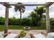 Landscaped backyard featuring a stone fire pit surrounded by lush greenery, offering a serene outdoor retreat at 1327 Wayne Ave, New Smyrna Beach, FL 32168