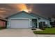 Charming single-story home featuring a well-maintained lawn, two-car garage, and lovely curb appeal at 1327 Wayne Ave, New Smyrna Beach, FL 32168