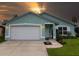 Charming single-story home featuring a well-maintained lawn, two-car garage, and lovely curb appeal at 1327 Wayne Ave, New Smyrna Beach, FL 32168