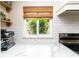 Bright kitchen featuring quartz counters, white subway tile backsplash, and bamboo window shades at 1327 Wayne Ave, New Smyrna Beach, FL 32168