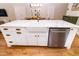 Kitchen island featuring a farmhouse sink, white cabinets, stainless steel dishwasher, and barstool seating at 1327 Wayne Ave, New Smyrna Beach, FL 32168