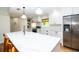 Kitchen with white cabinets, marble countertops, stainless steel appliances, and eat-in island at 1327 Wayne Ave, New Smyrna Beach, FL 32168