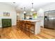 Bright kitchen with white cabinets, a large island, and stainless steel appliances at 1327 Wayne Ave, New Smyrna Beach, FL 32168