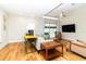 Bright living room featuring hardwood floors, neutral walls, and sliding glass doors to an outdoor space at 1327 Wayne Ave, New Smyrna Beach, FL 32168