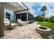 Relax in style on this backyard patio with a pergola, comfortable chairs, and a charming fire pit feature at 1327 Wayne Ave, New Smyrna Beach, FL 32168