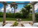 Enjoy the lush greenery and scenic backyard from this relaxing outdoor patio with a cozy fire pit at 1327 Wayne Ave, New Smyrna Beach, FL 32168