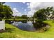 Scenic view of a tranquil pond surrounded by lush greenery, creating a serene and picturesque setting at 1327 Wayne Ave, New Smyrna Beach, FL 32168