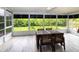 Sunroom with wood floors and multiple screened windows providing ample light and outdoor views at 1327 Wayne Ave, New Smyrna Beach, FL 32168