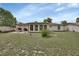This backyard features a cozy patio set, grill, and a lush green lawn, perfect for outdoor entertaining at 1382 Coronet Dr, Deltona, FL 32725