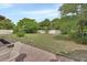 Expansive backyard offers ample green space and is surrounded by mature trees, perfect for outdoor activities at 1382 Coronet Dr, Deltona, FL 32725
