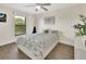Cozy bedroom with a window, a floral comforter, and hardwood flooring at 1382 Coronet Dr, Deltona, FL 32725