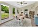 Bright dining room with windows, modern rug, and backyard views; adjacent bar with beverage cooler at 1382 Coronet Dr, Deltona, FL 32725
