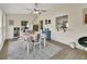 Bright dining room with ceiling fan, modern rug, and pass through to the kitchen for easy serving at 1382 Coronet Dr, Deltona, FL 32725