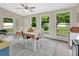 Bright dining room with large windows and a stylish table setting at 1382 Coronet Dr, Deltona, FL 32725